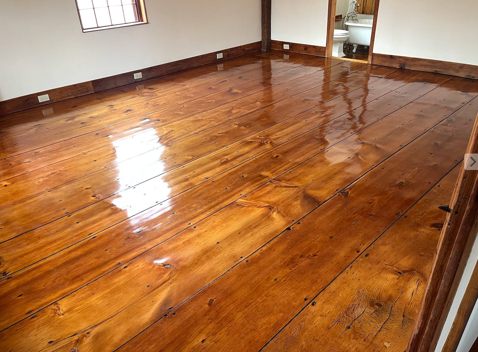 Refinished wide-plank pine floor