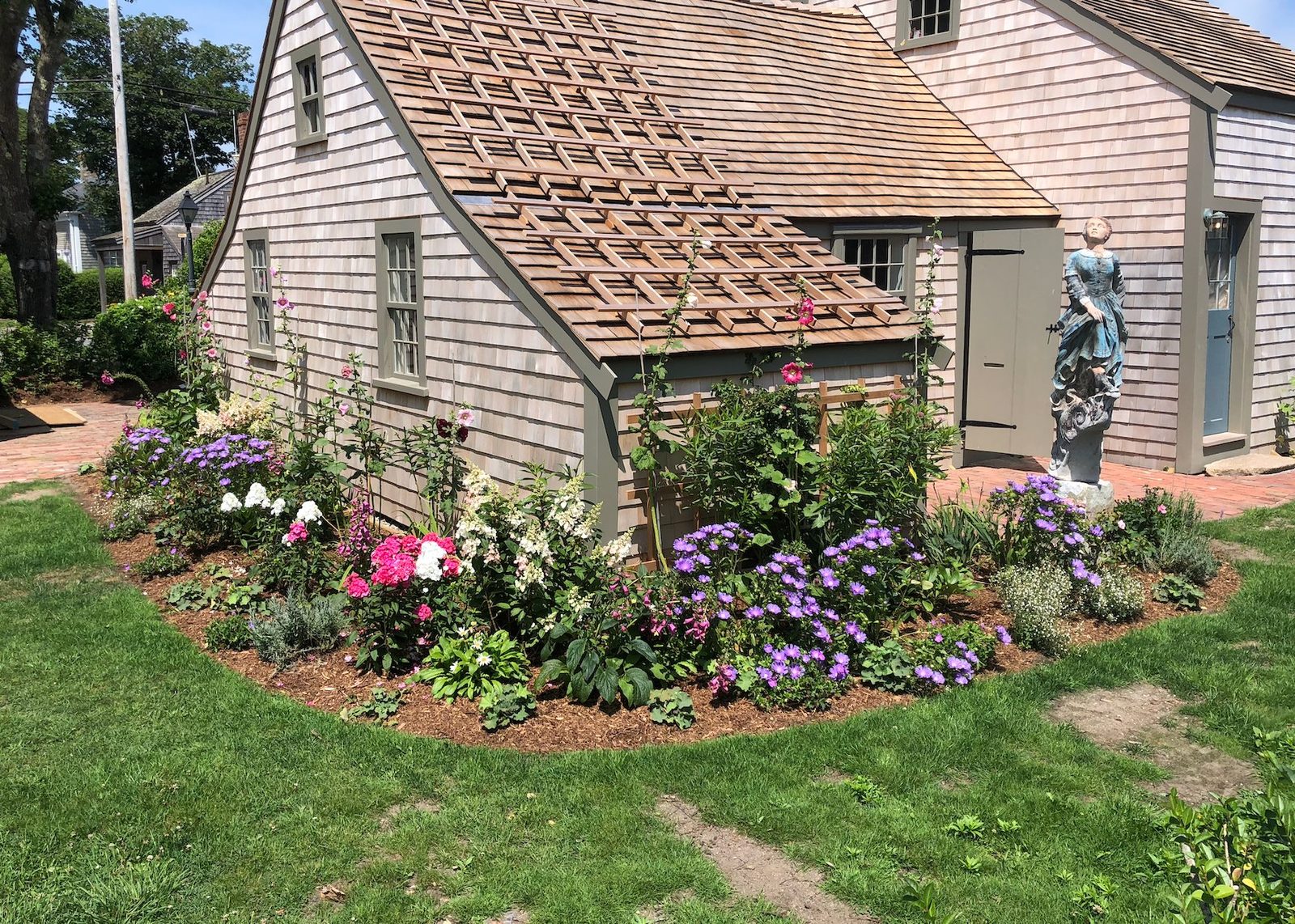 Sconset cottage restoration with cedar roof and gardens